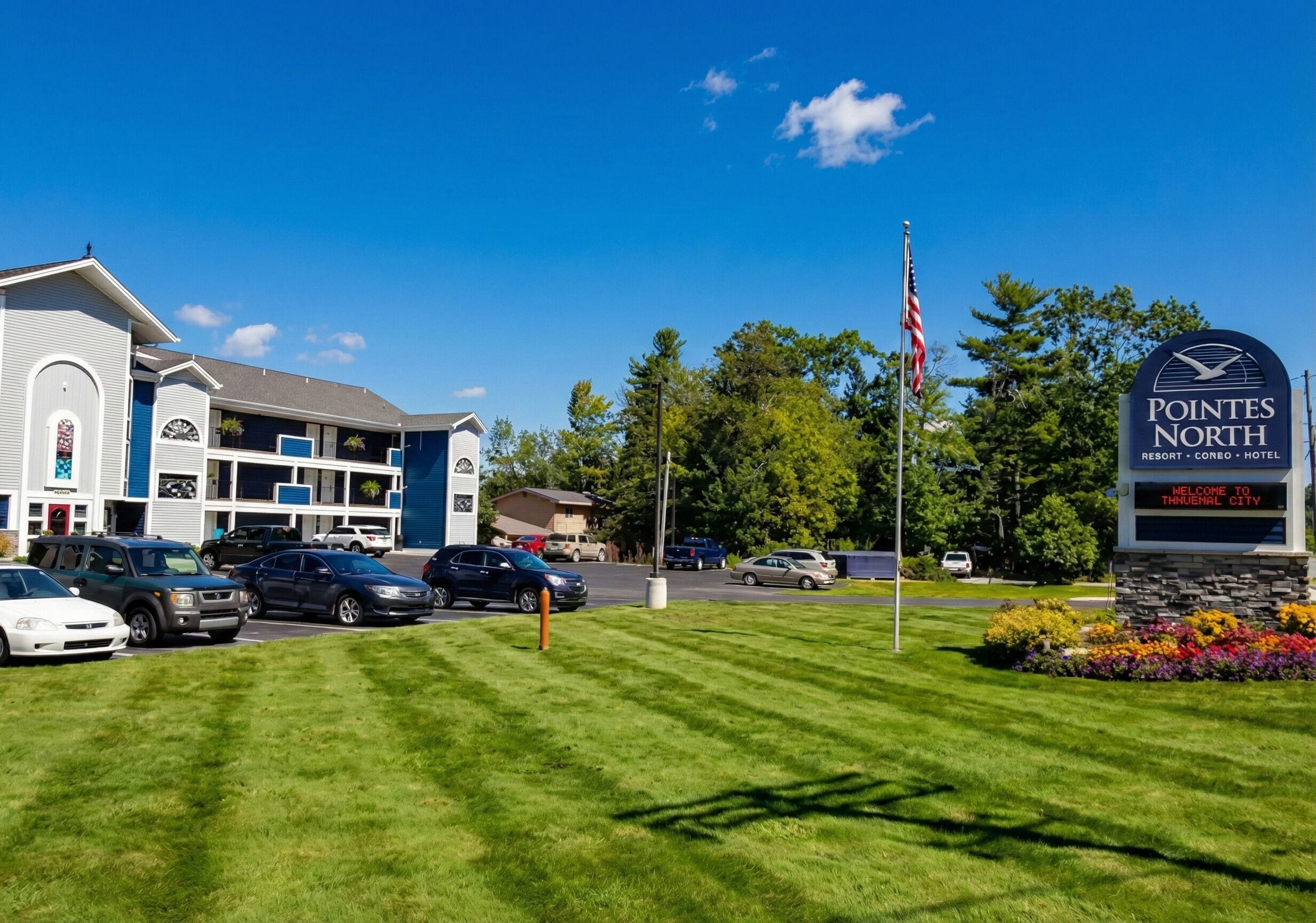 Un hotel con un cartel que dice 'Pointex North Resort - Condo - Hotel' dando la bienvenida a visitantes en Thruway City.