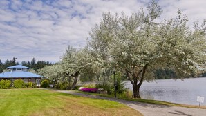 A lakeside property with a house, a pathway, and a sign indicating a private dock. - Inn On Long Lake (Nanaimo)