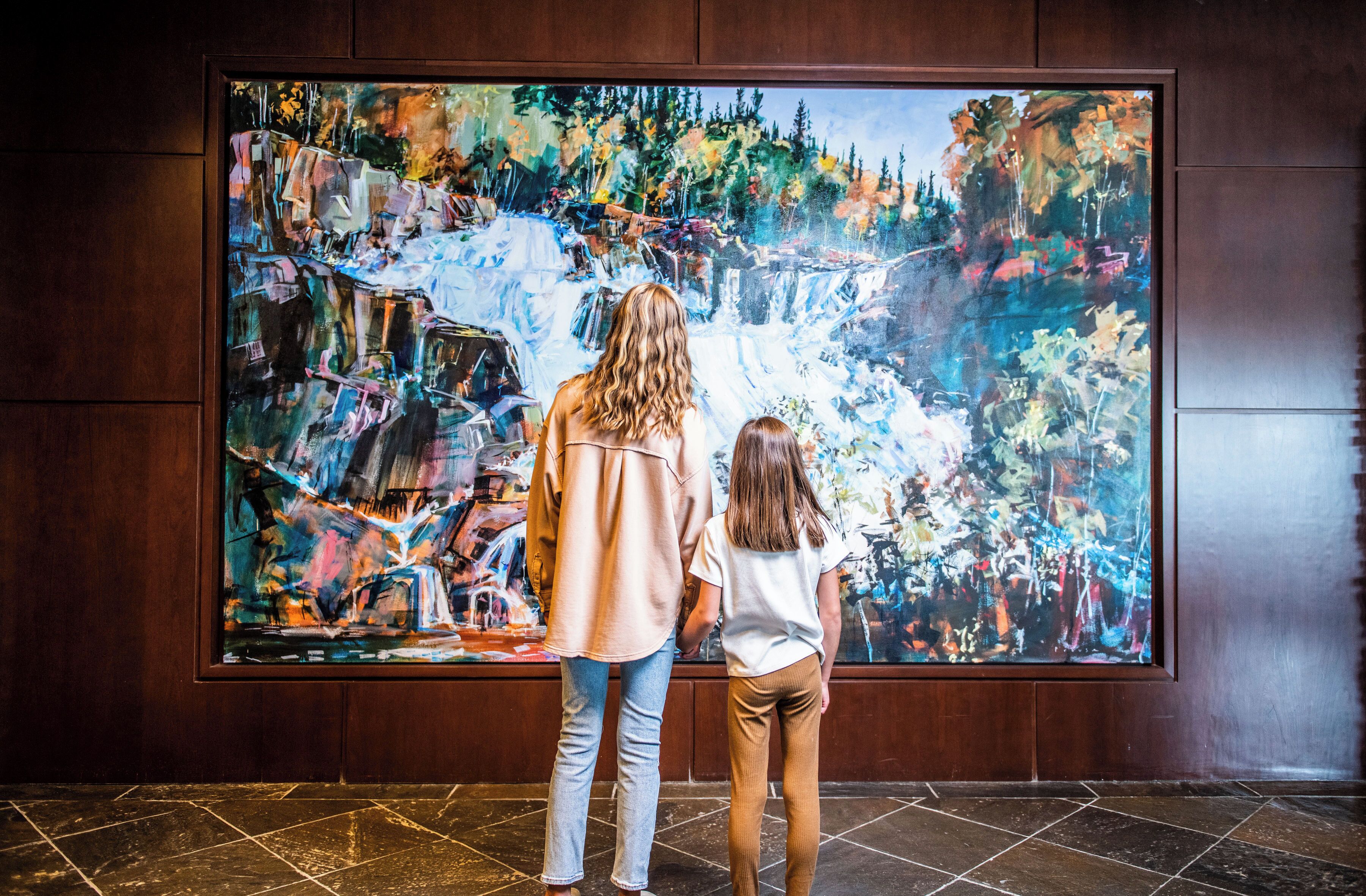 A large abstract painting on a wall.