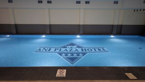 A swimming pool with a logo for ANI PLAZA HOTEL and a no-jumping sign. - Ani Plaza Hotel (Yerevan)