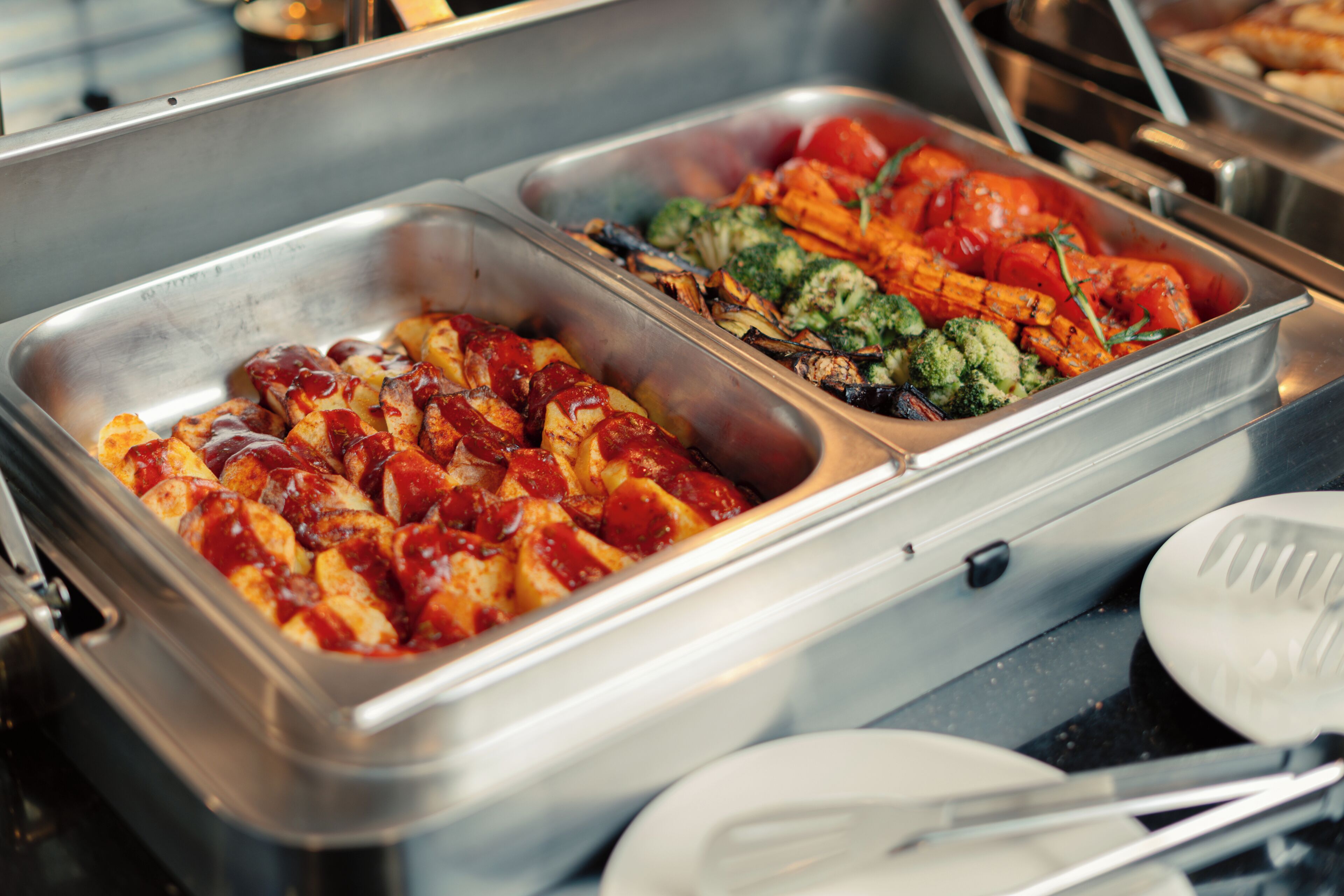 A buffet with various food items including grilled vegetables and meats.