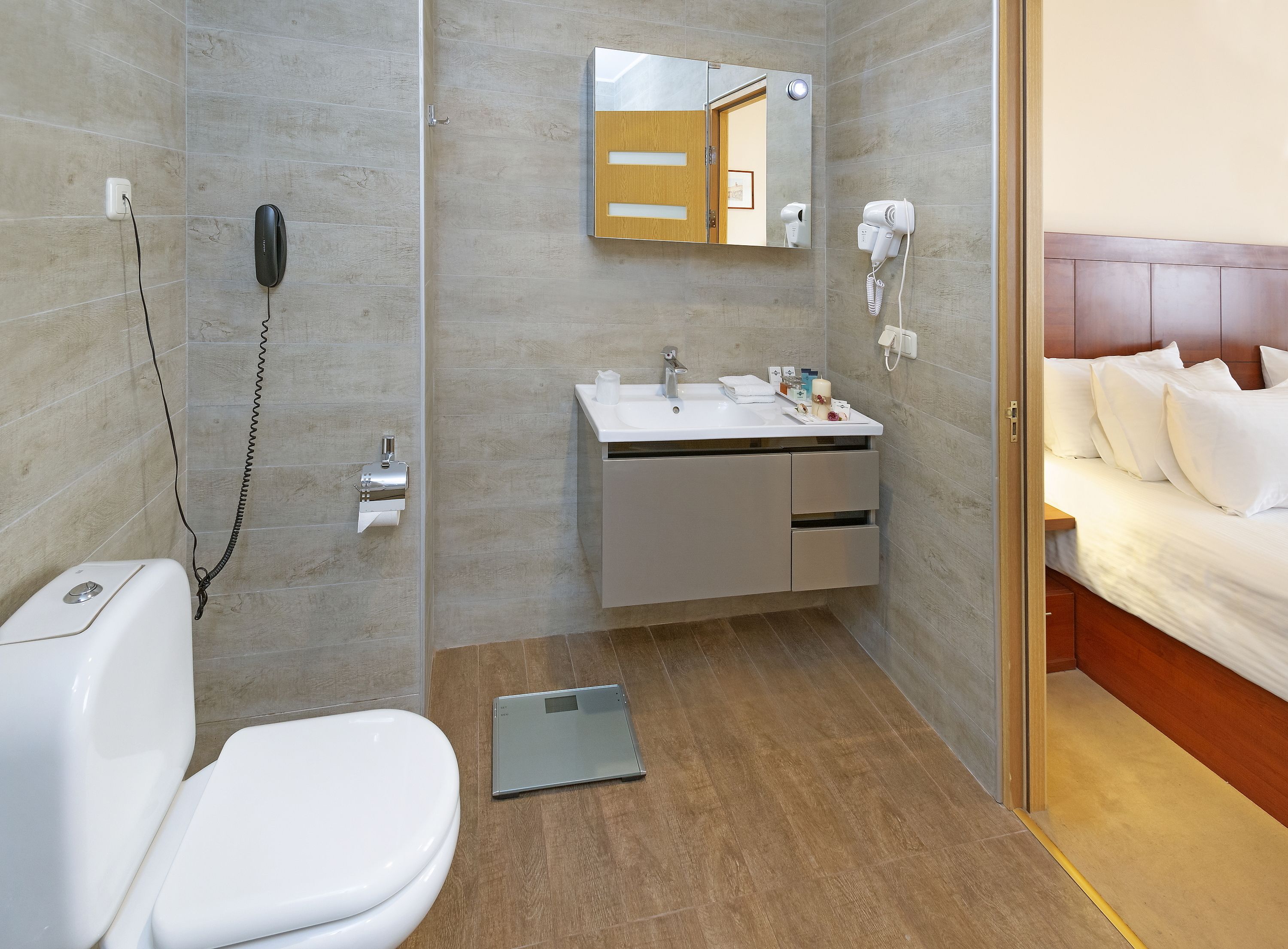 A modern bathroom with a toilet, sink, and shower area.