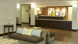 A reception area with a sofa, a table, and a reception desk.