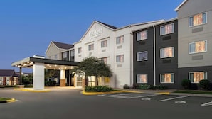 A Fairfield Inn & Suites hotel with a covered entrance, multiple floors, and a parking lot.