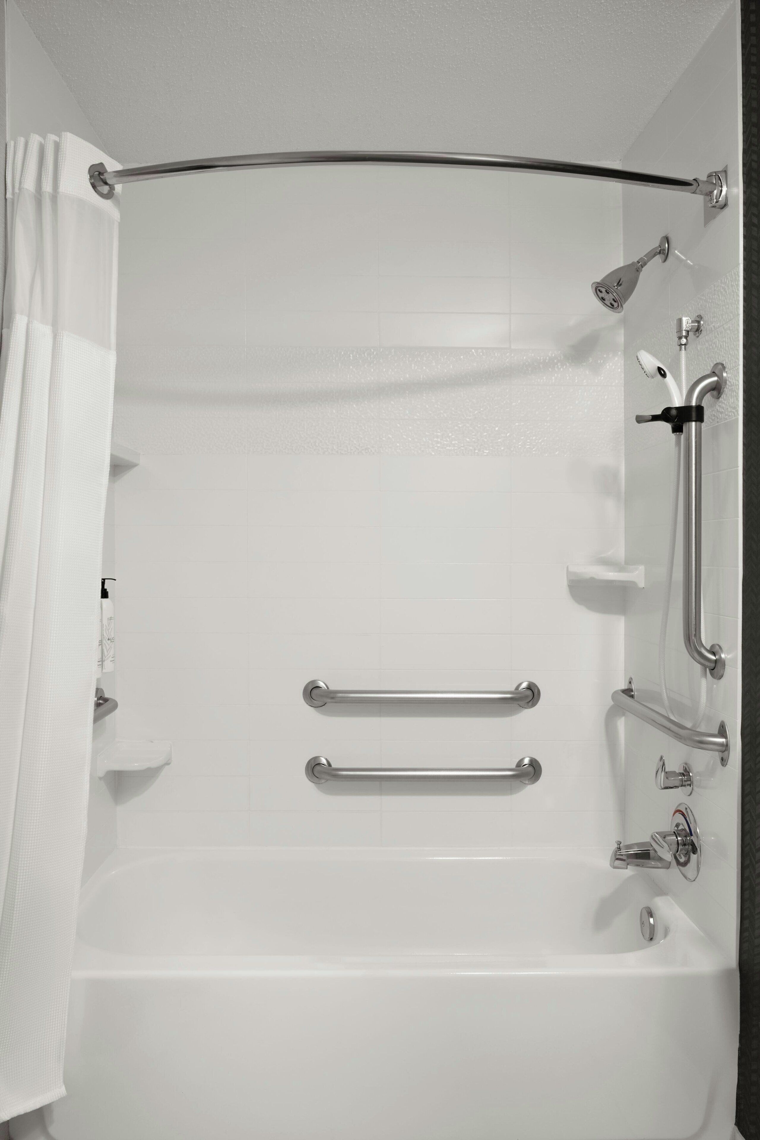 combined shower/bathtub, designer toiletries, hair dryer, towels