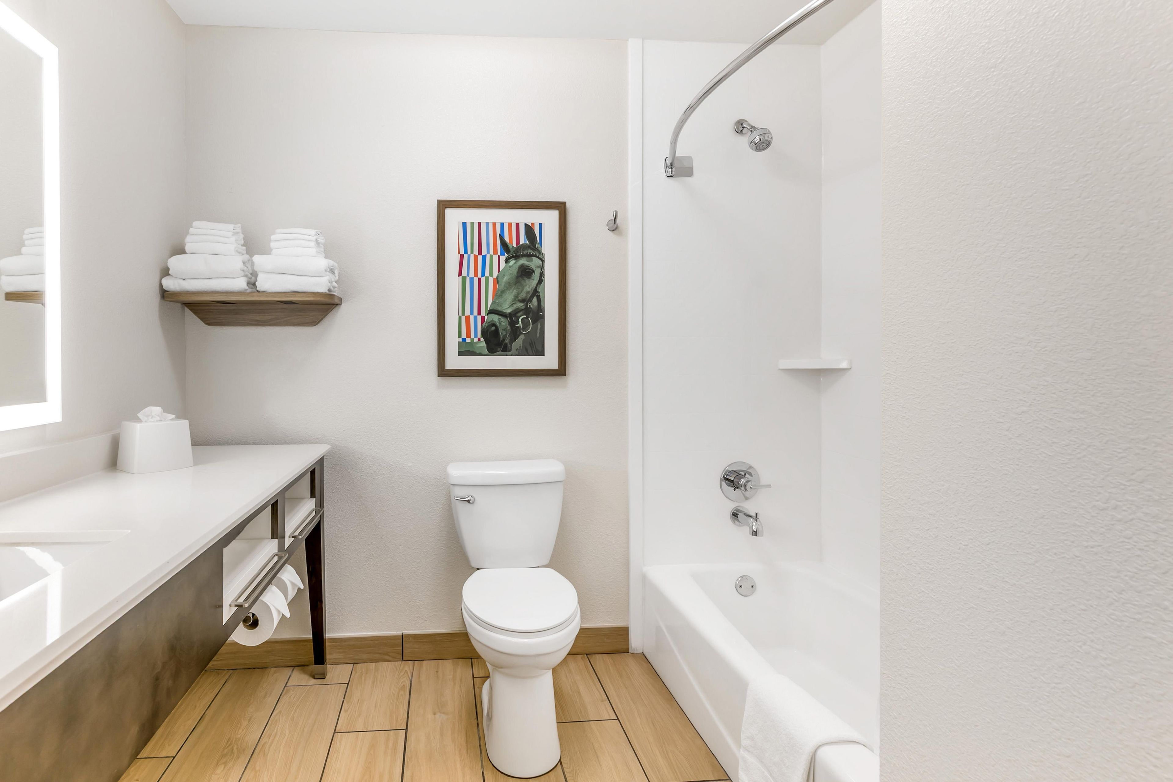 A modern bathroom with a toilet, sink, and bathtub.