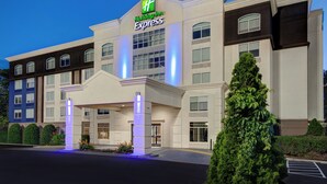A Holiday Inn Express building with a modern facade, large windows, and a well-lit entrance. - Holiday Inn Express Marietta - Atlanta Northwest by IHG (Marietta)
