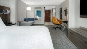 A hotel room with a large bed, a desk with a chair, a TV, and a bathroom visible through an open door. - Holiday Inn Express Marietta - Atlanta Northwest by IHG (Marietta)