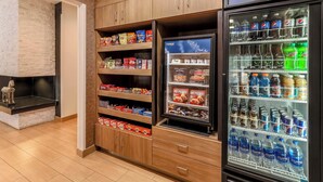 A vending machine stocked with various beverages and snacks, including hot drinks and bottled water.