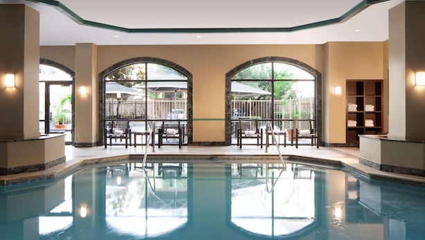 A swimming pool with a clear view of the surrounding area, including seating and a view of the outdoors. - Embassy Suites by Hilton Houston Near the Galleria (Houston)