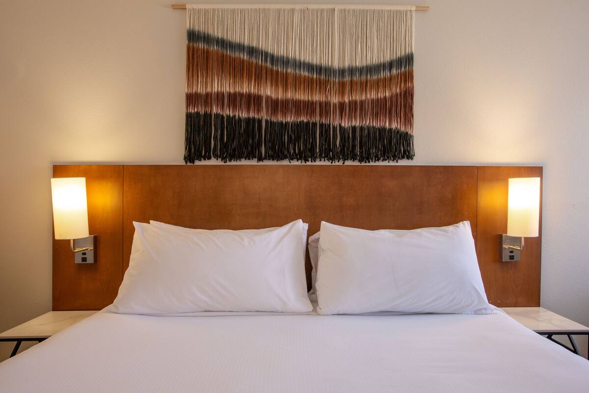 pillow-top beds, desk, laptop workspace, blackout curtains