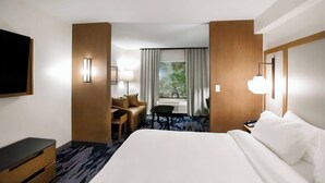 A hotel room with a large bed, a desk, a chair, and a window with curtains. - Fairfield Inn & Suites by Marriott Louisville Airport (Louisville)