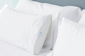 A bed with white bedding and pillows, one of which has a label reading "Pure". - Courtyard by Marriott Denver Airport (Denver)