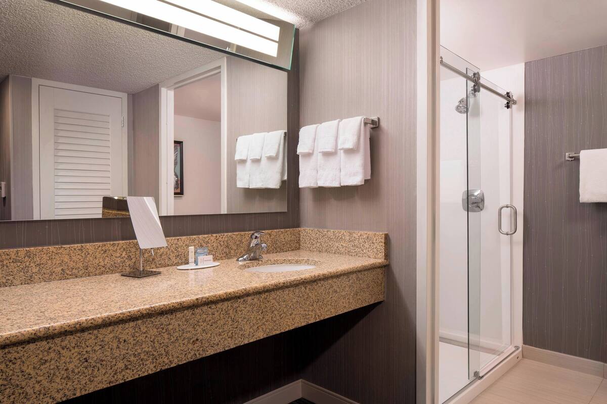 combined shower/bathtub, designer toiletries, hair dryer, towels