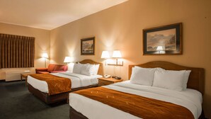 A hotel room with two beds, a sofa, and two lamps. - Super 8 by Wyndham Cherokee (Cherokee)