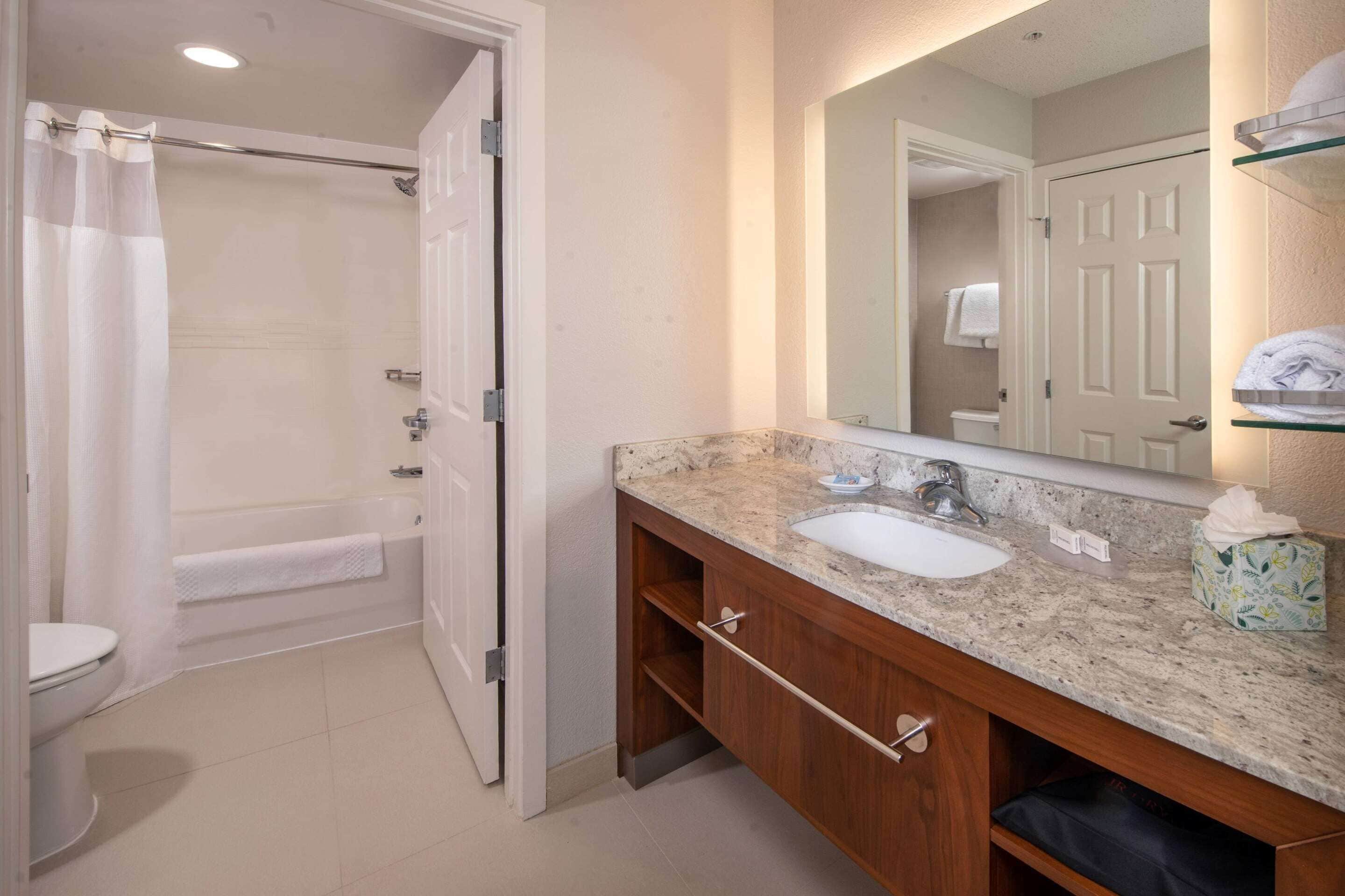 combined shower/bathtub, designer toiletries, hair dryer, towels