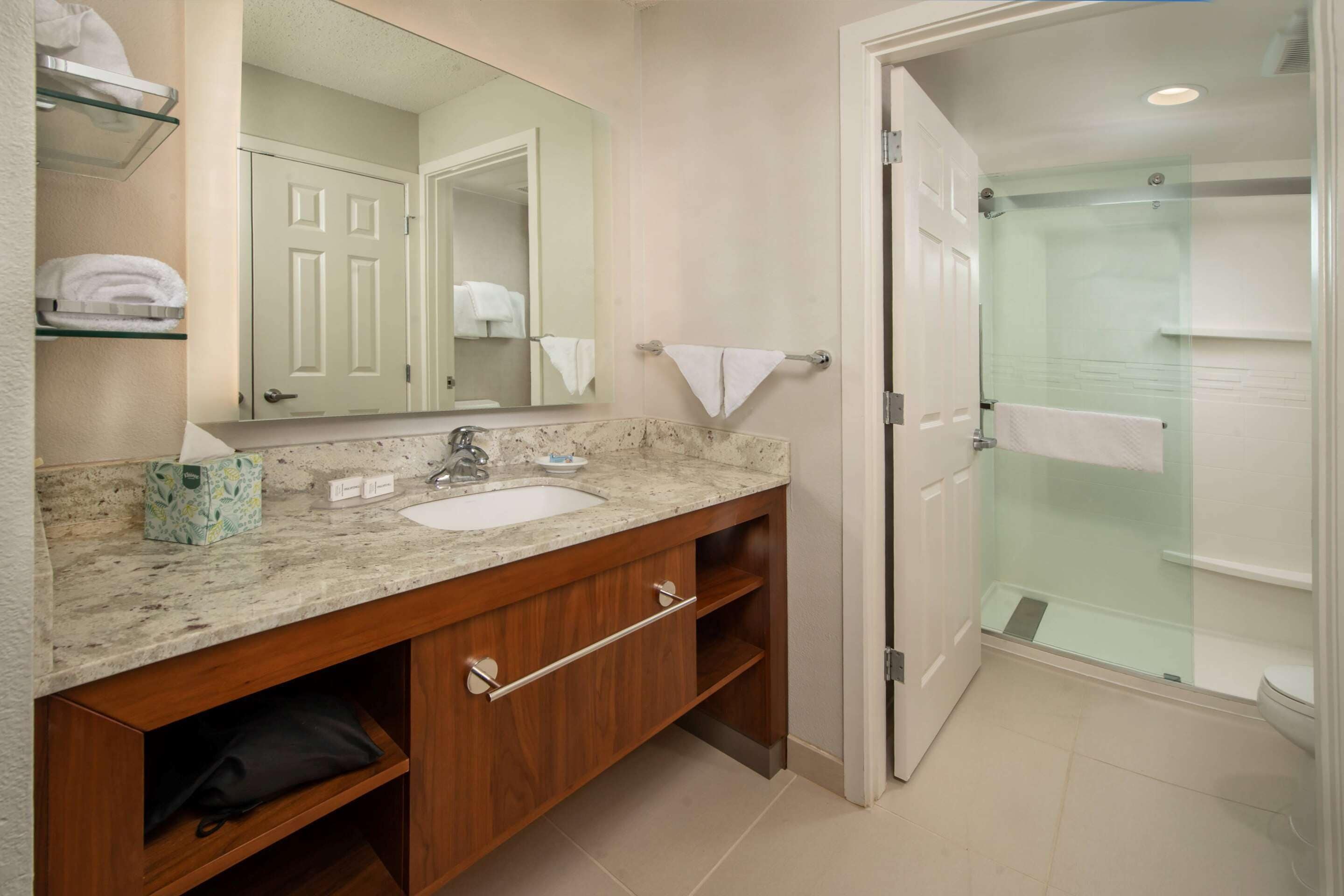 combined shower/bathtub, designer toiletries, hair dryer, towels