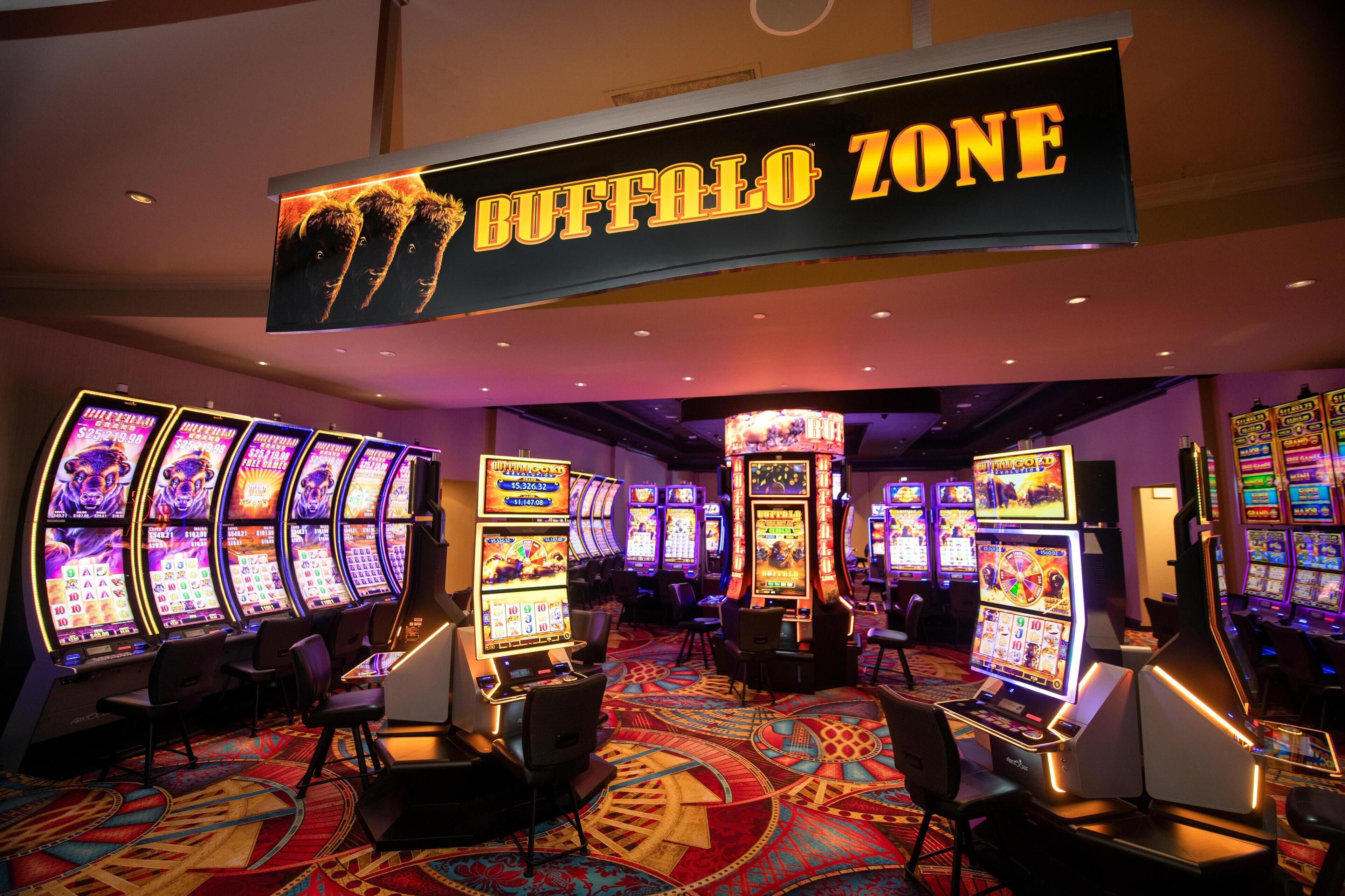 A casino area with multiple slot machines and a sign reading "BUFFALO ZONE".