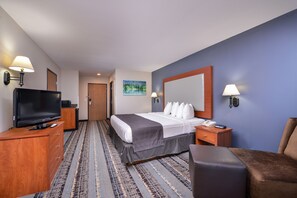 A hotel room with a bed, a TV, a desk, a chair, and a painting on the wall. - Best Western Newberg Inn (Newberg)