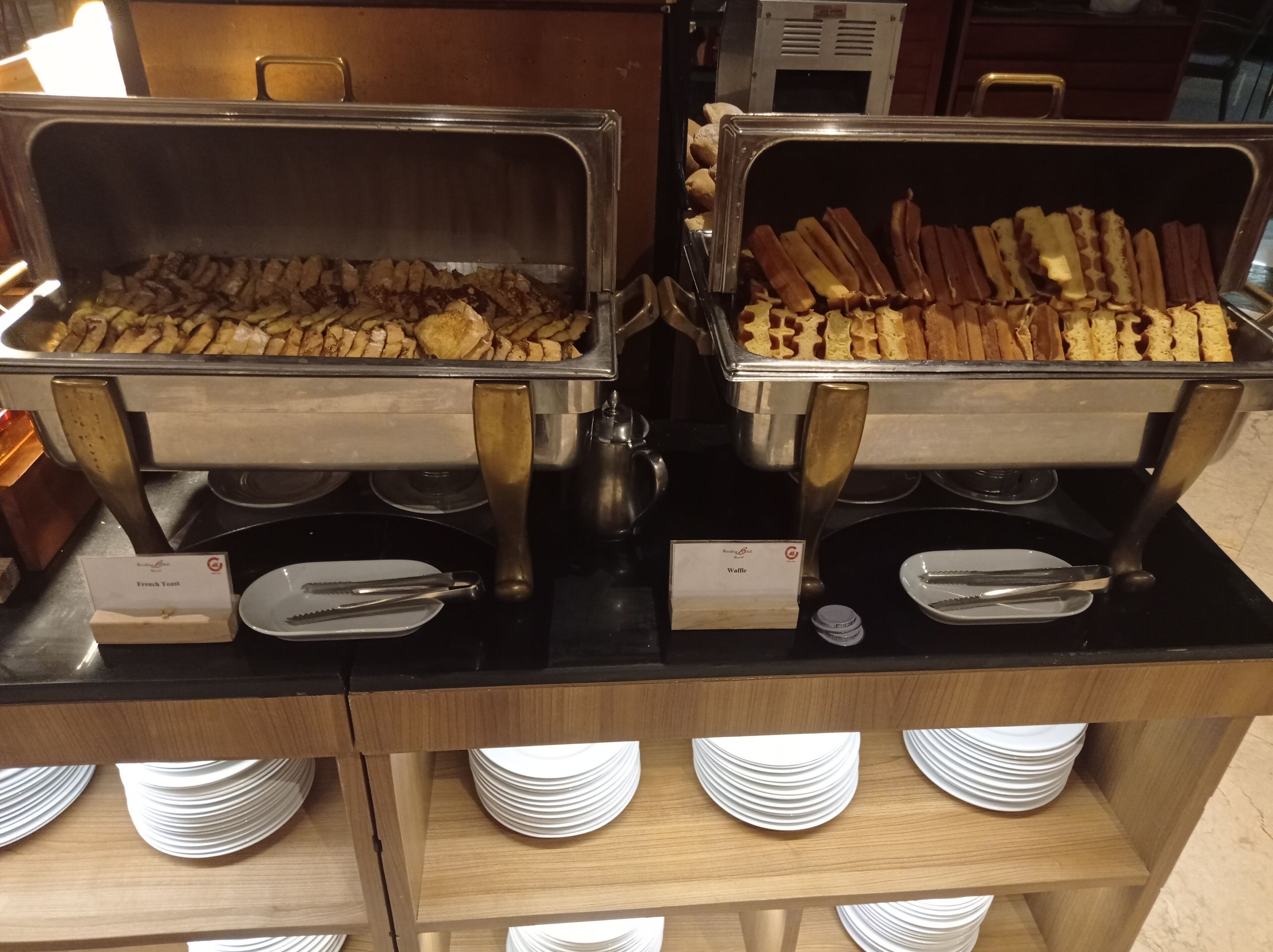 A buffet with French toast and waffles.