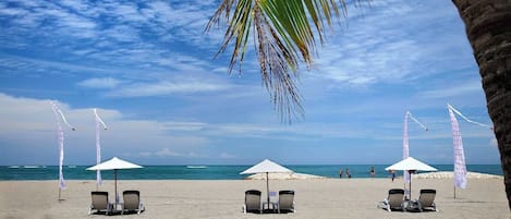 En privat strand, liggestole, parasoller