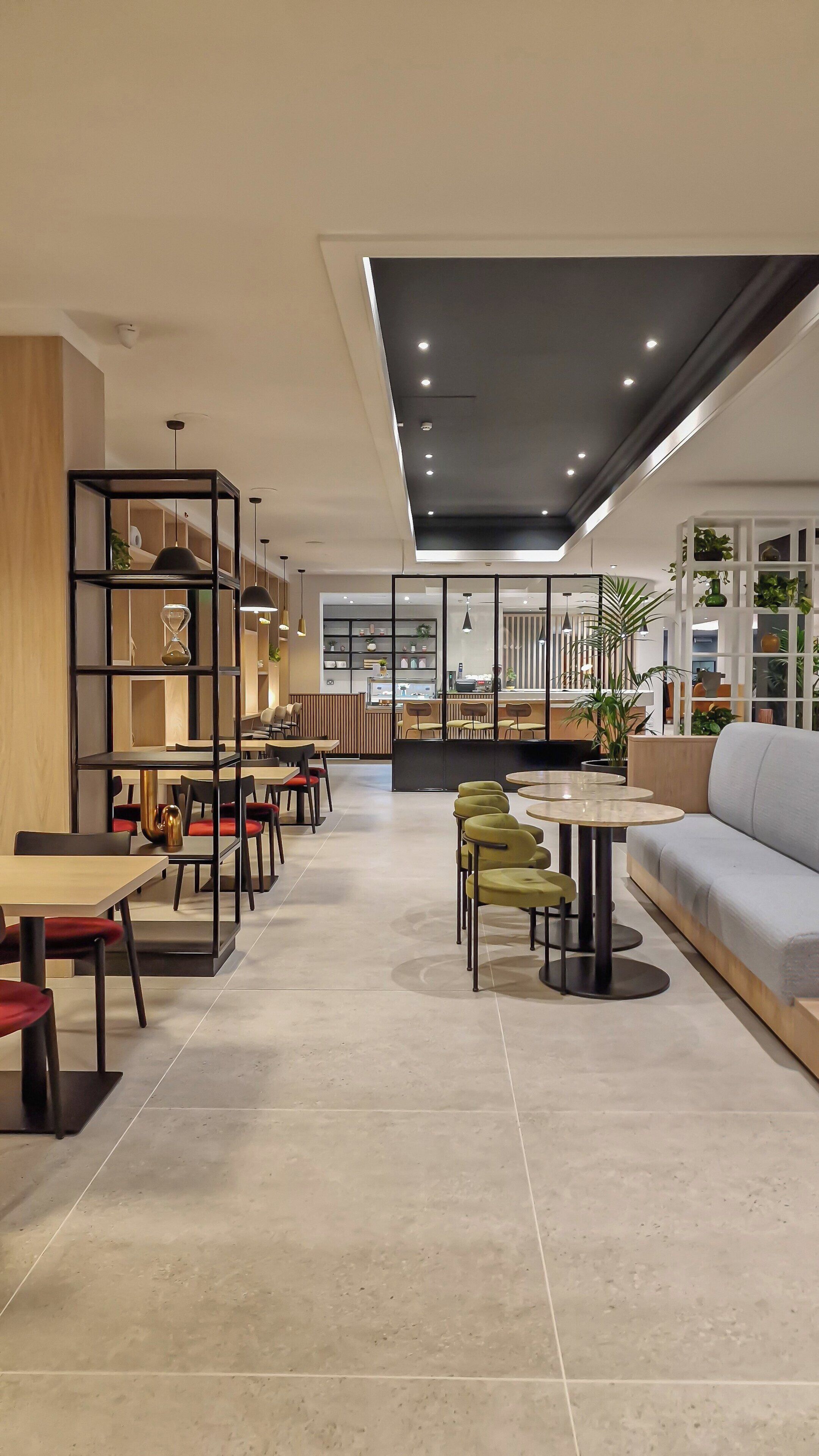 A modern interior with a dining area, seating, and a bar.