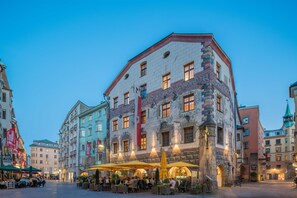 Un edificio histórico con un área de café en el patio.