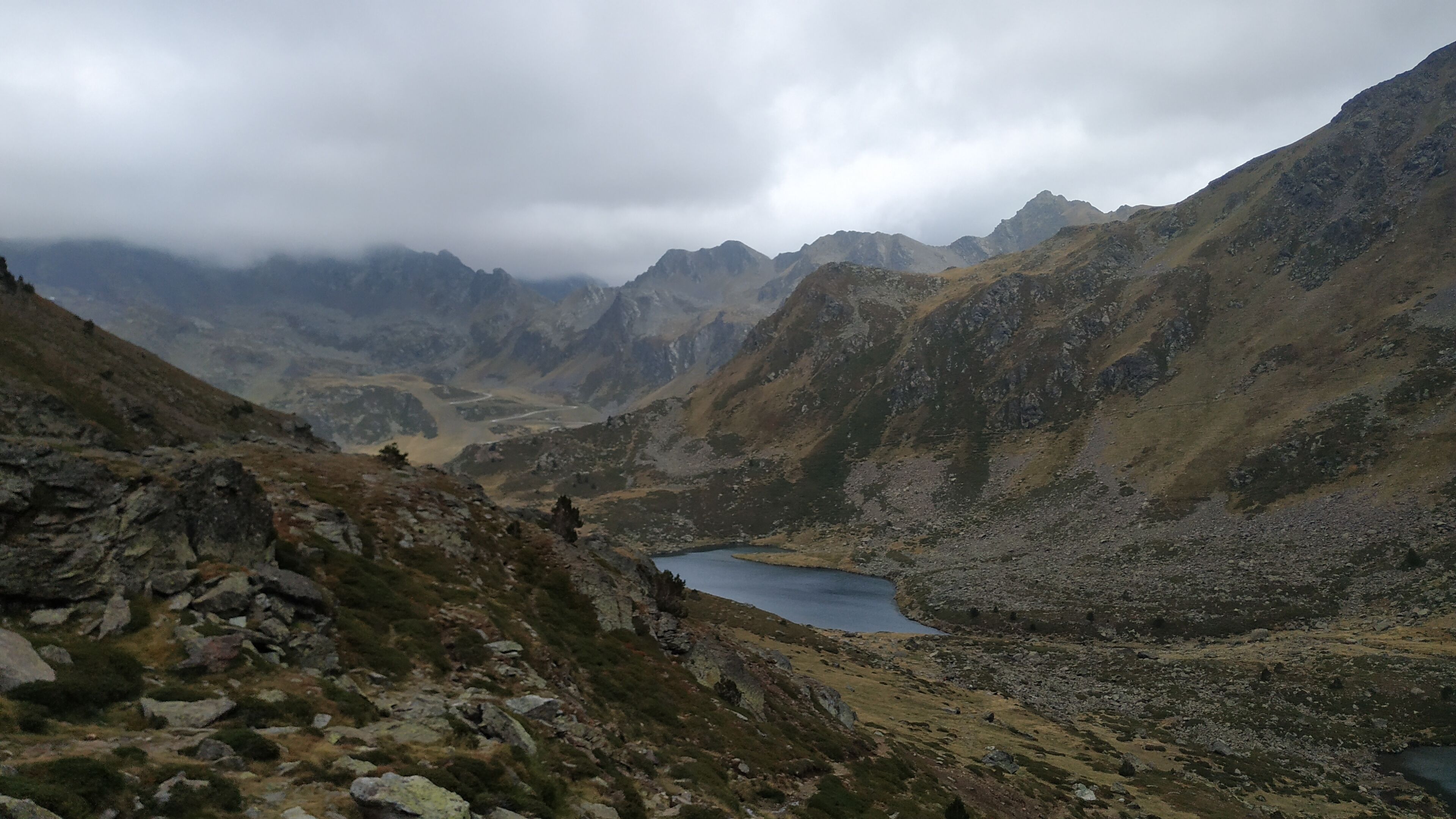 A mountainous landscape with a lake and rocky terrain.