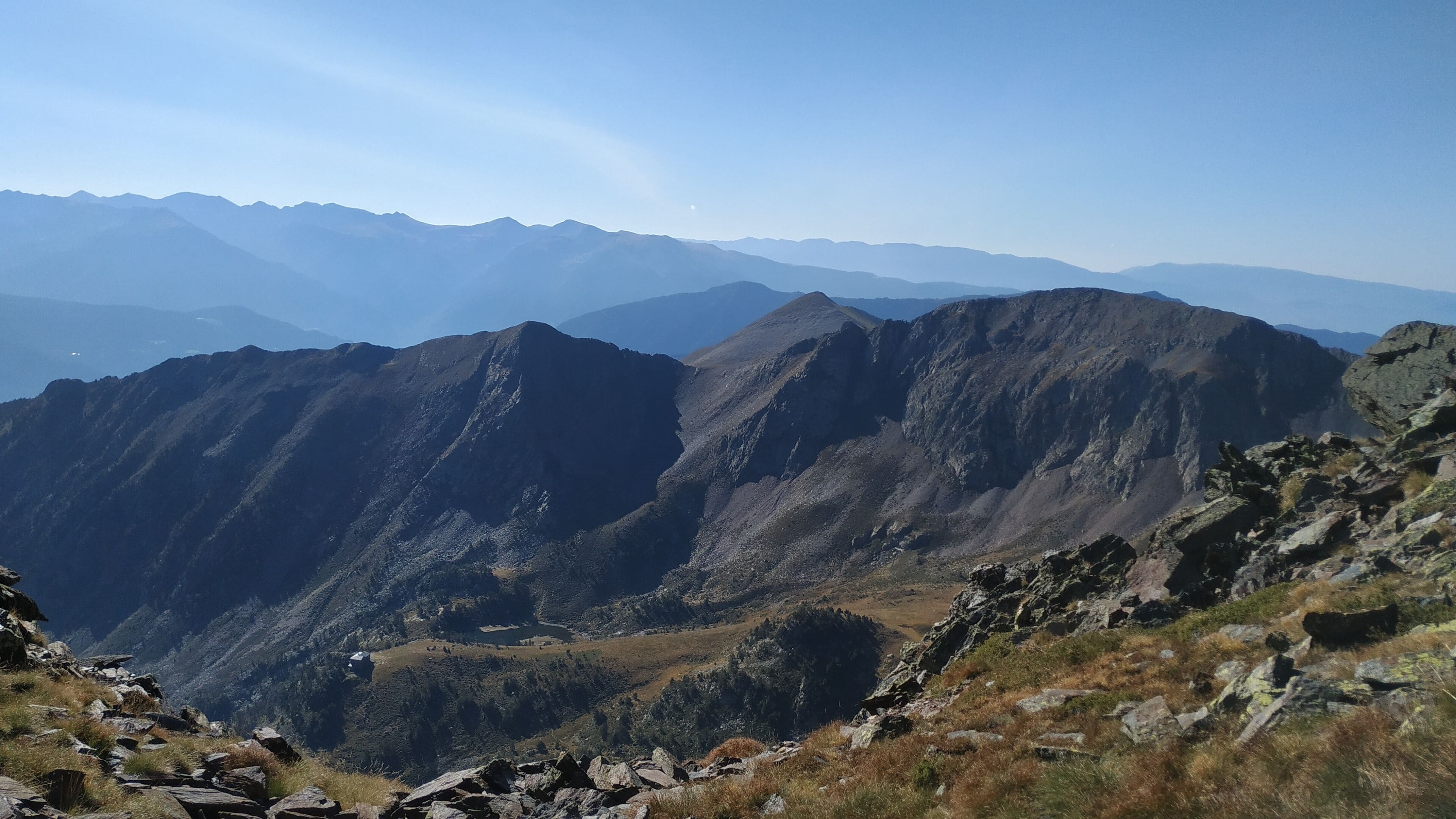 A mountainous landscape with rocky terrain and sparse vegetation.