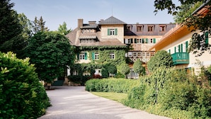 A traditional European-style building with a gravel pathway leading to the entrance.