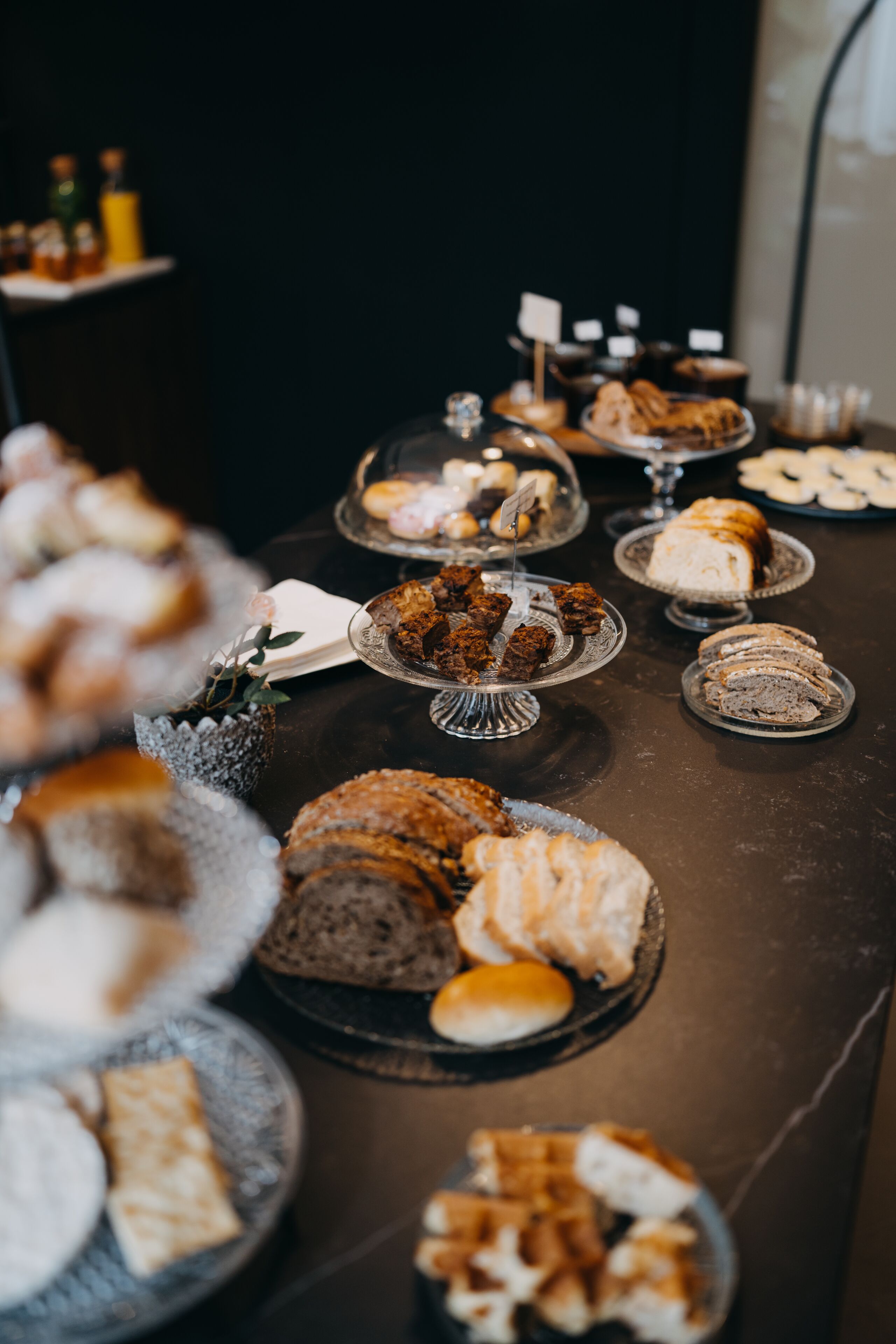 A buffet table with various desserts and pastries.