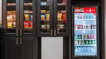 A vending machine with snacks and Coca-Cola.