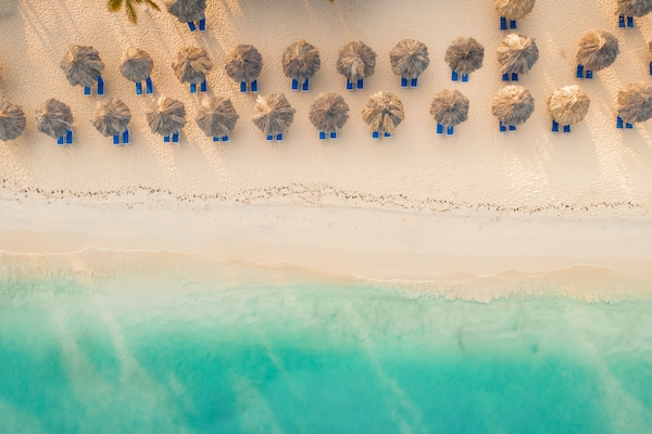 On the beach, white sand, sun loungers, beach umbrellas