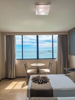 Deluxe Triple Room | Minibar, in-room safe, desk, blackout drapes