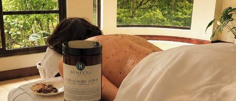 A room with a bed, a bottle of coffee body scrub, and a plate with food.