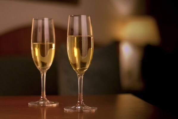 Two glasses of white wine on a table with a blurred background. - Hotel Ariston & Ariston Patio (Prague)