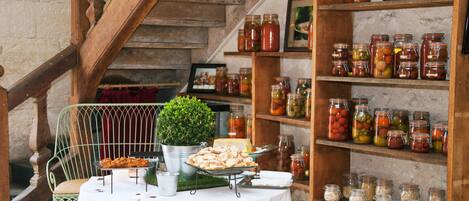 A table with food items and jars of preserves.