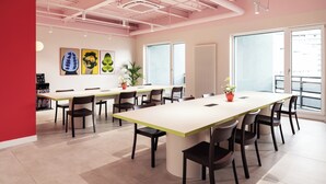 A modern conference room with a large table, chairs, and artwork on the walls. - Numa Berlin Kudamm (Berlin)