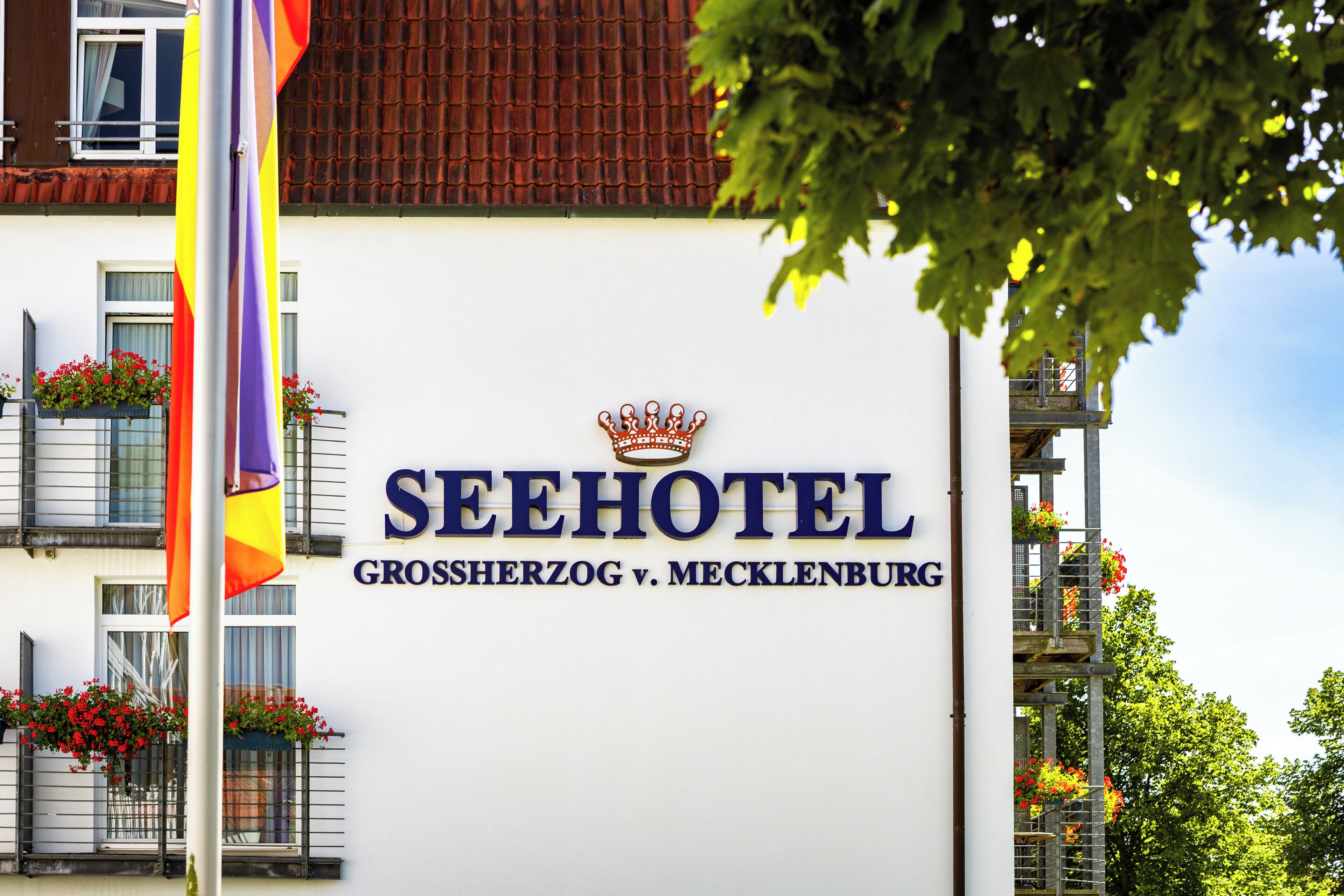 A hotel sign with a crown emblem, indicating a possible royal or prestigious status.
