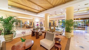 A spacious lobby with a wooden ceiling, large potted plants, comfortable seating, and a modern interior design. - InterContinental Real San Pedro Sula by IHG (San Pedro Sula)