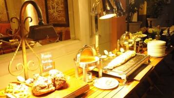 A buffet setup with various food items and a sign indicating 'Russian Australian Lamb'.