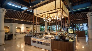 A spacious lobby with a central island, high ceilings with wooden beams, and a modern chandelier. - Novotel Bogor Golf Resort & Convention Center (Bogor)