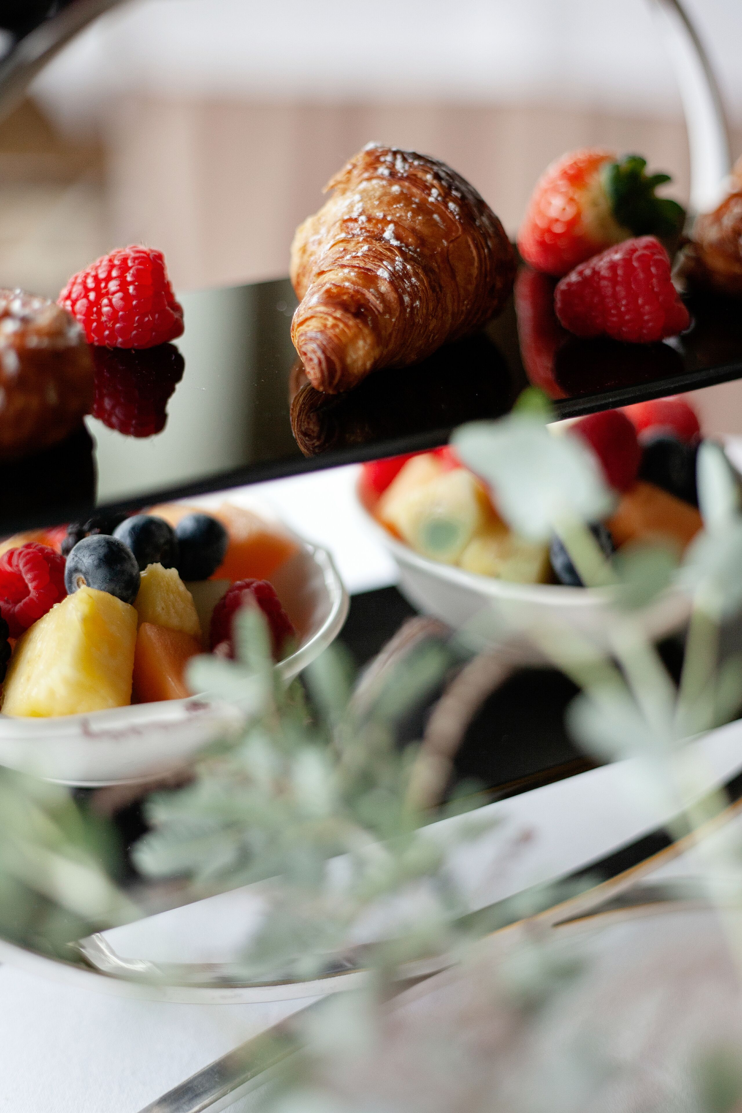 A dessert tray with pastries and fresh fruits.