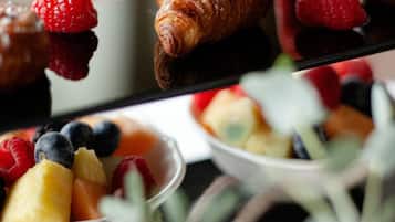 A dessert tray with pastries and fresh fruits.