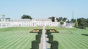 A large, symmetrical building with a central pathway leading to a formal garden. - The K Club (Straffan)