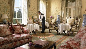 A formal dining room with a chandelier, floral wallpaper, and classic furniture. - The K Club (Straffan)
