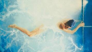 A person swimming in a pool.