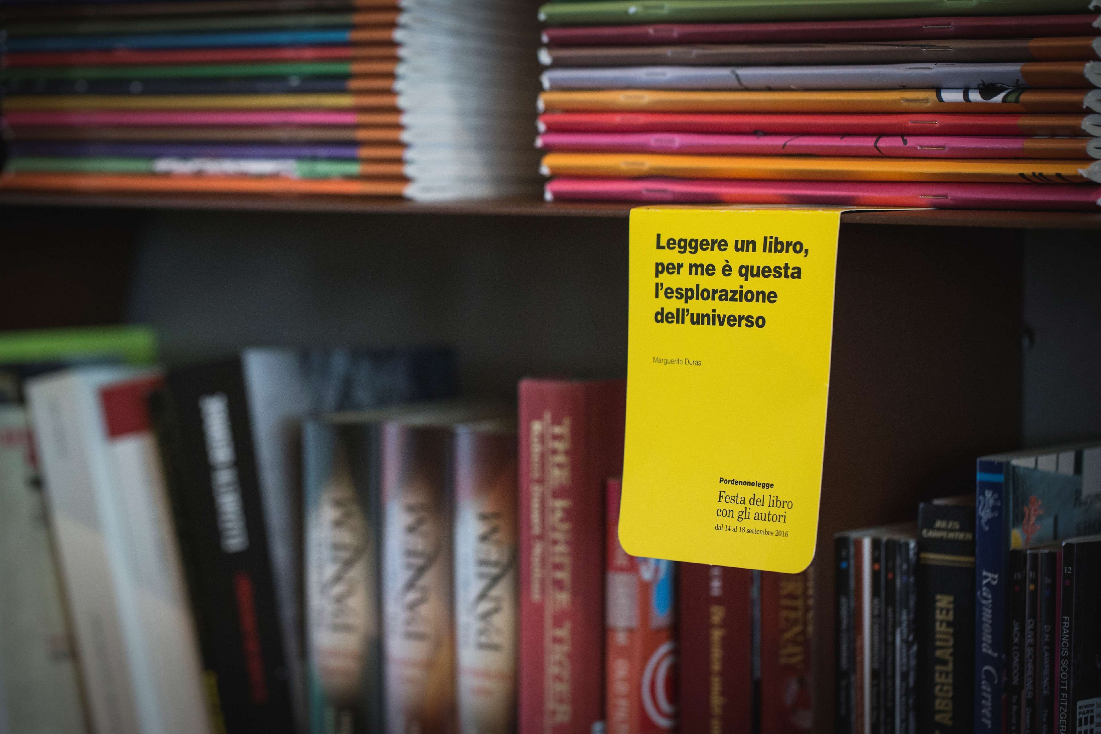 A bookshelf with a yellow sign.