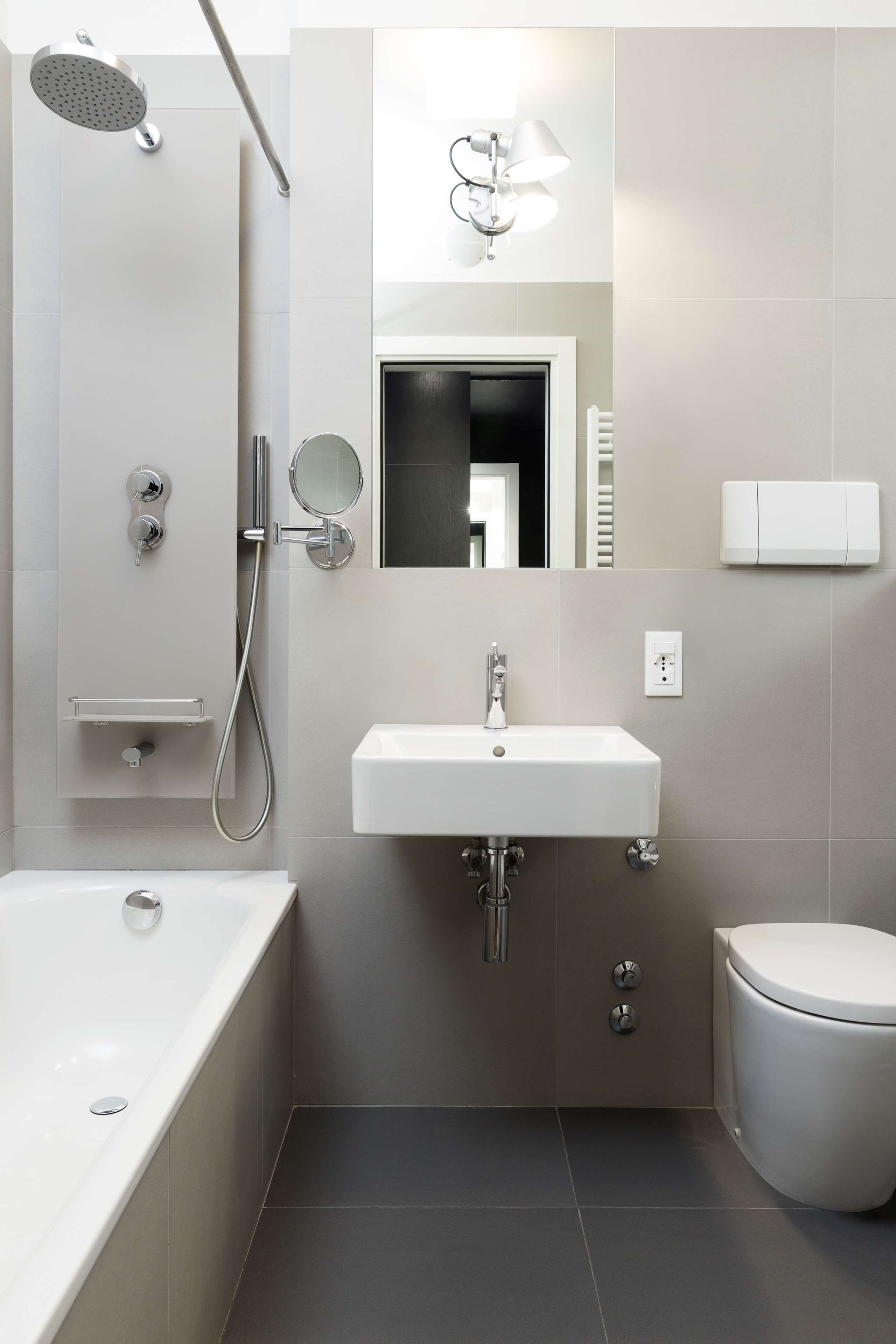 A modern bathroom with a bathtub, a sink, a toilet, and a shower.