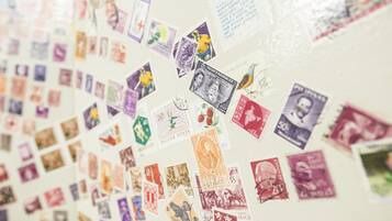 A wall covered with various stamps and postcards.